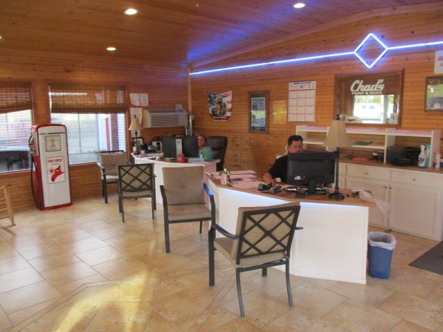A man sits at a desk in front of a coca cola machine