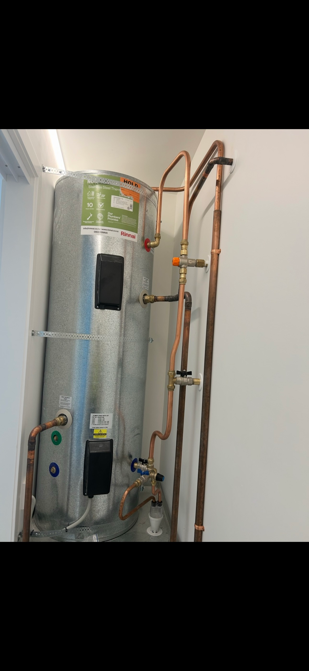 A man is holding a tool belt full of tools.