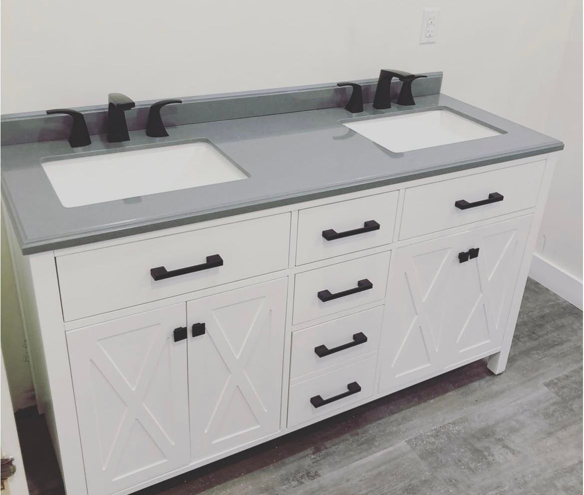 White bathroom vanity with gray countertop, two sinks, and black fixtures.