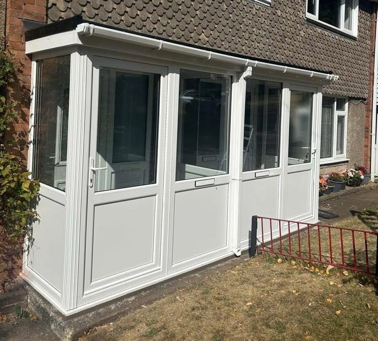 A stone house with a porch and a white door