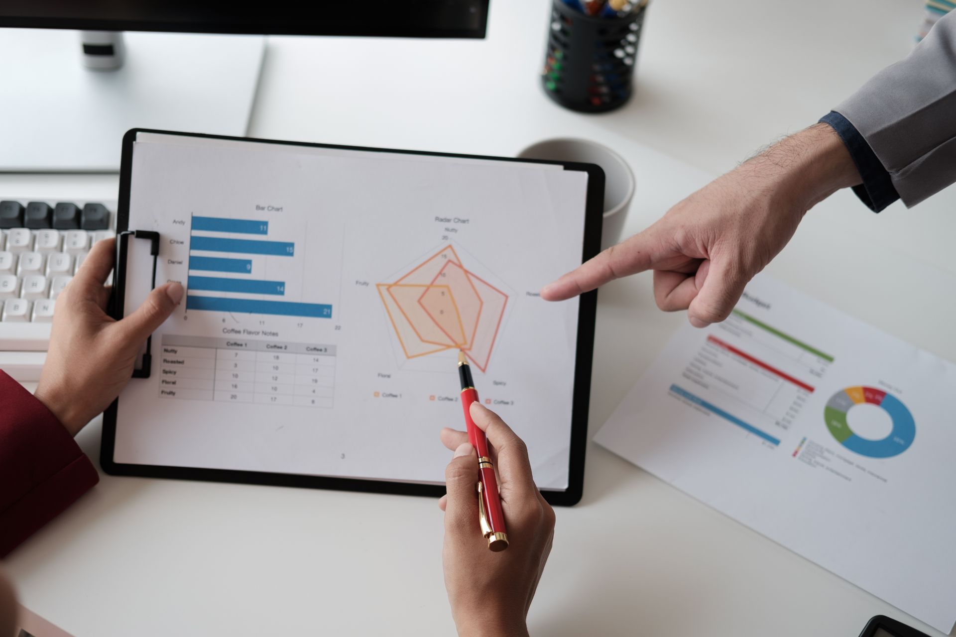 A picture of 2 people analyzing Market Trends on a graph.