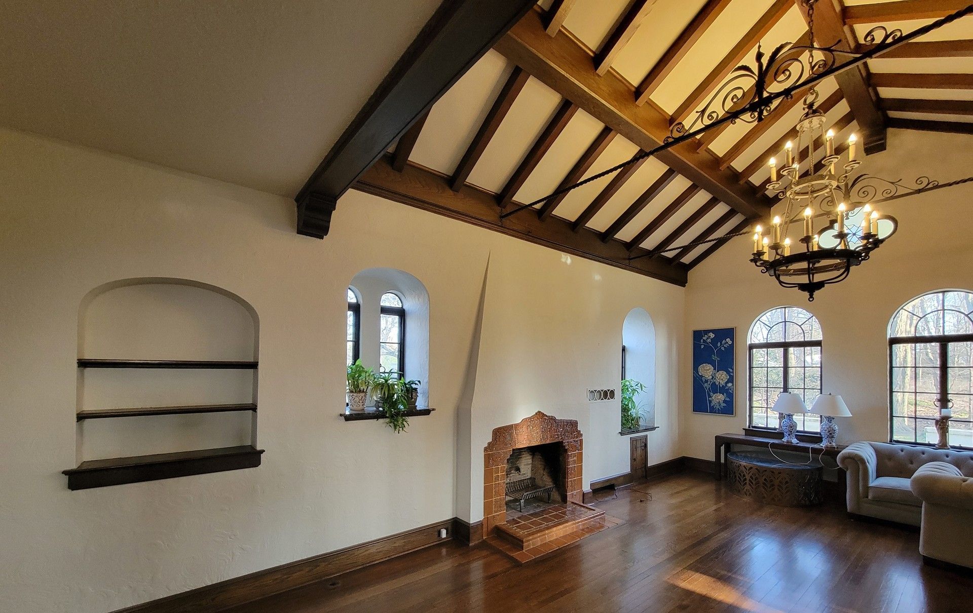 A living room with a fireplace and a chandelier