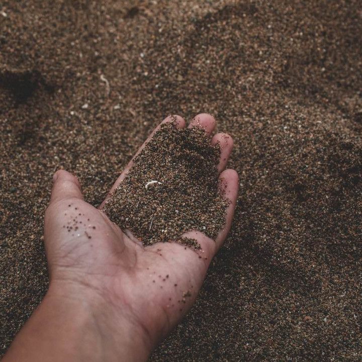 Sand on a Person's Hand