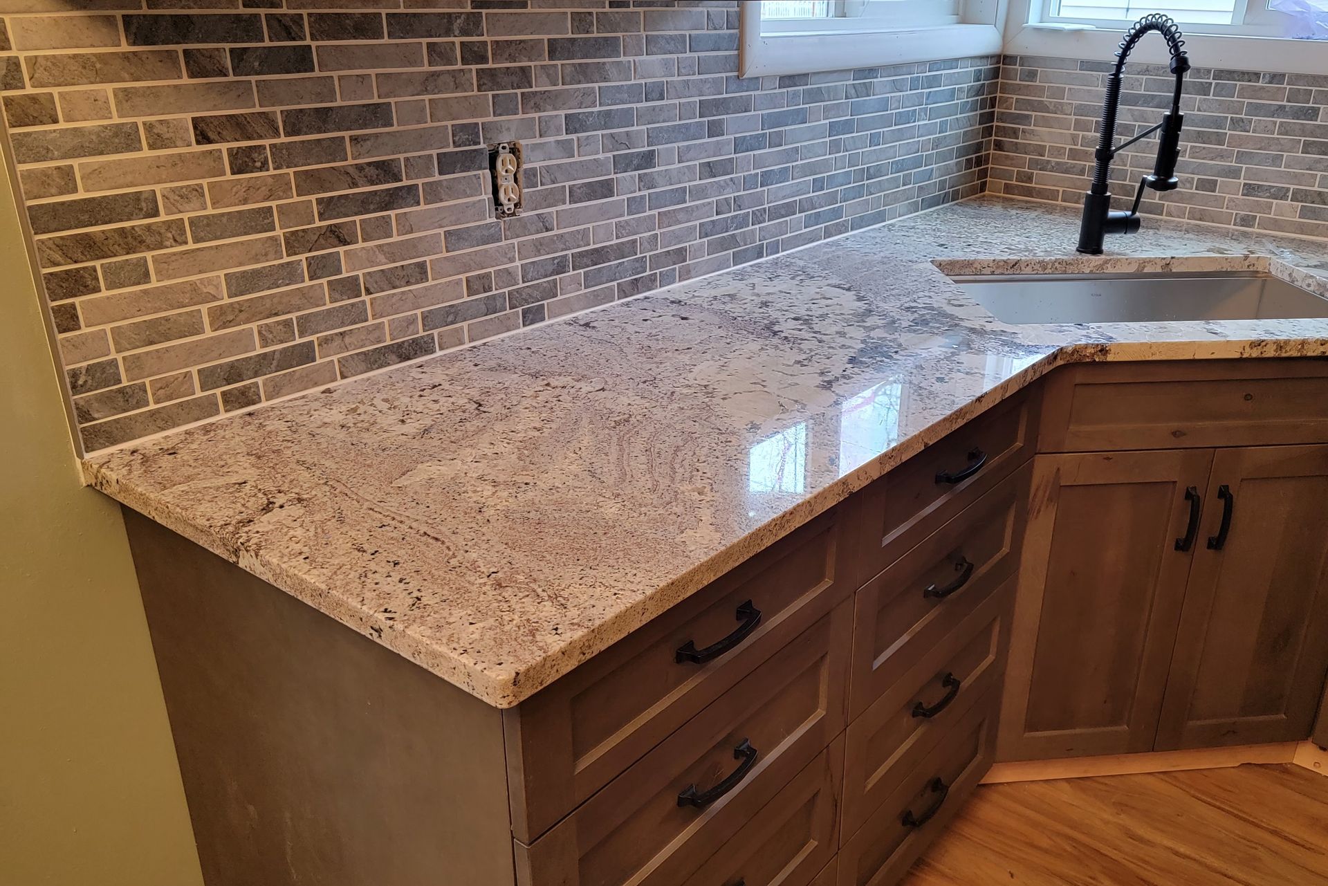 A kitchen with granite counter tops and a sink.