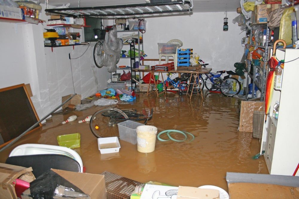 A flooded garage with a lot of stuff in it