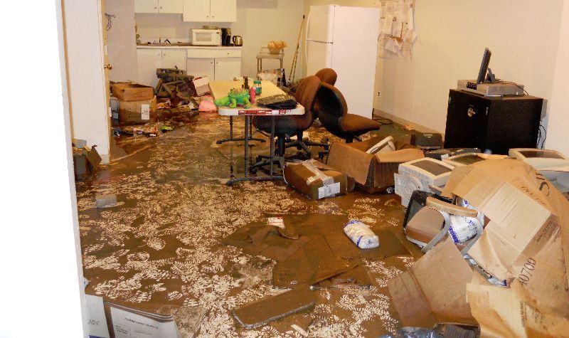 A messy room with a lot of boxes on the floor