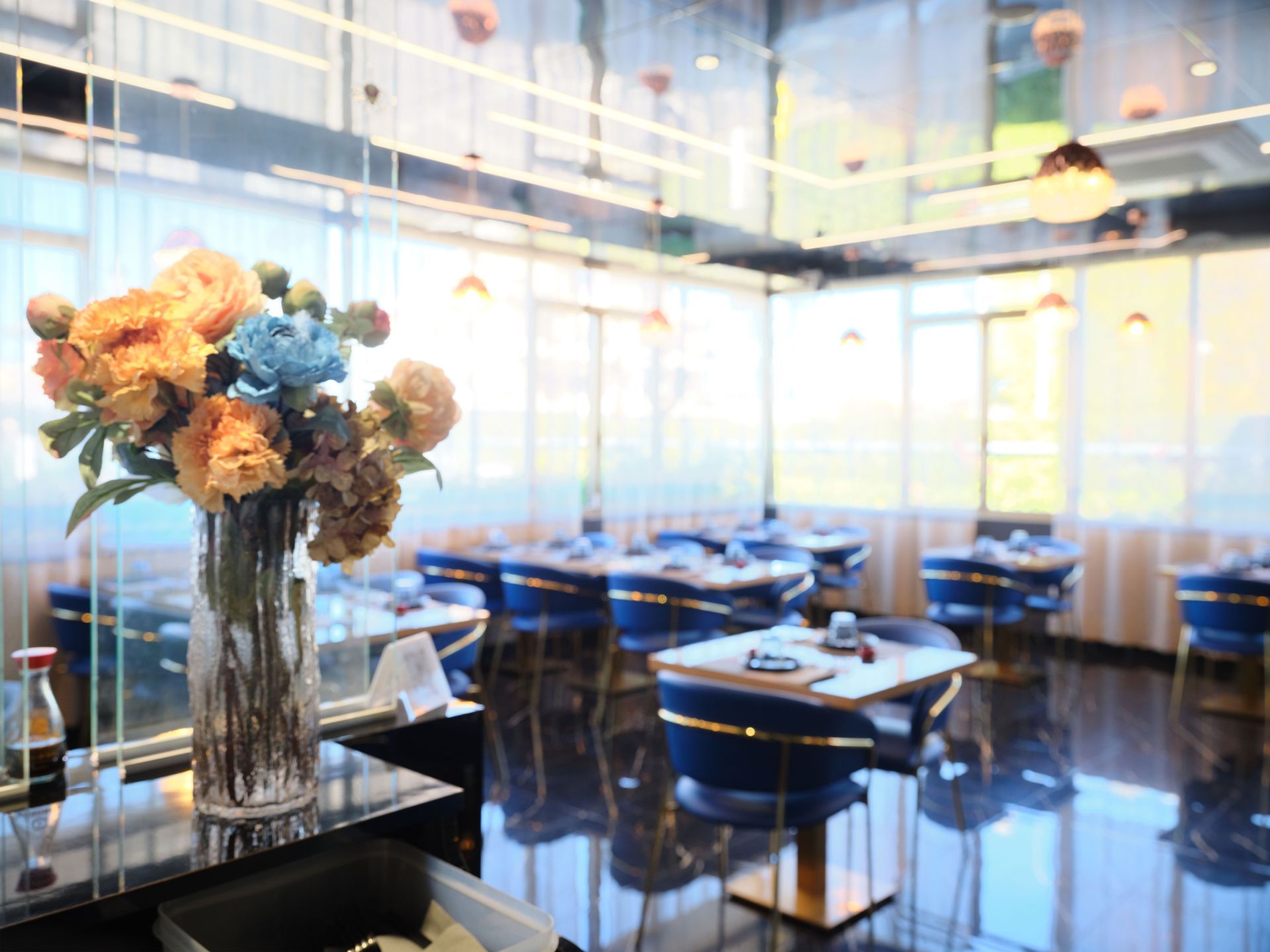 Un vaso di fiori è appoggiato su un tavolo in un ristorante.