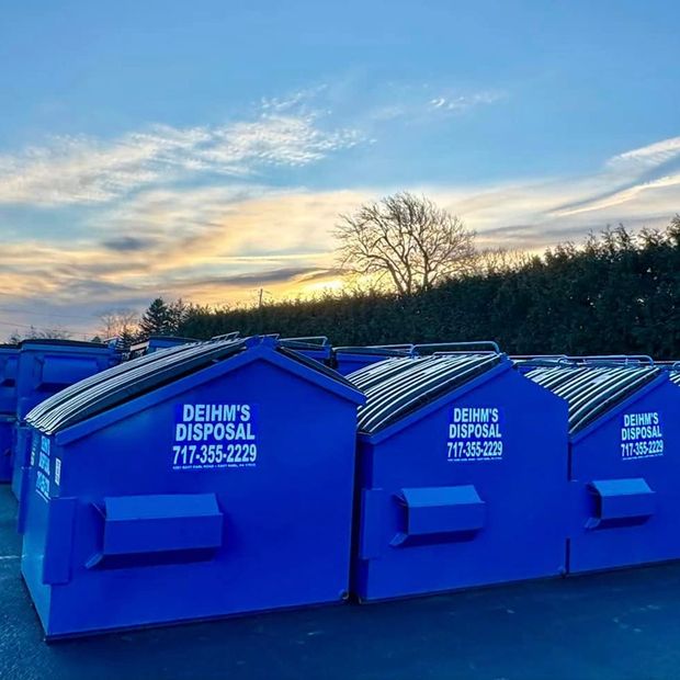 A row of garbage trucks from Deihm's Disposal of PA