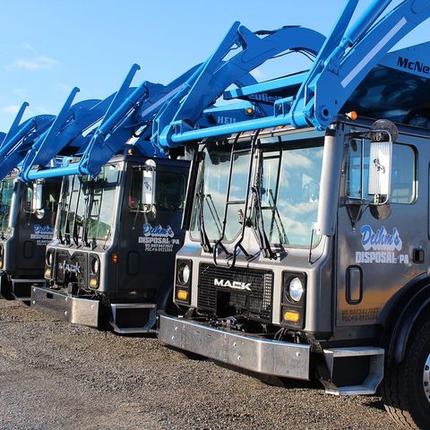 A row of garbage trucks from Deihm's Disposal of PA