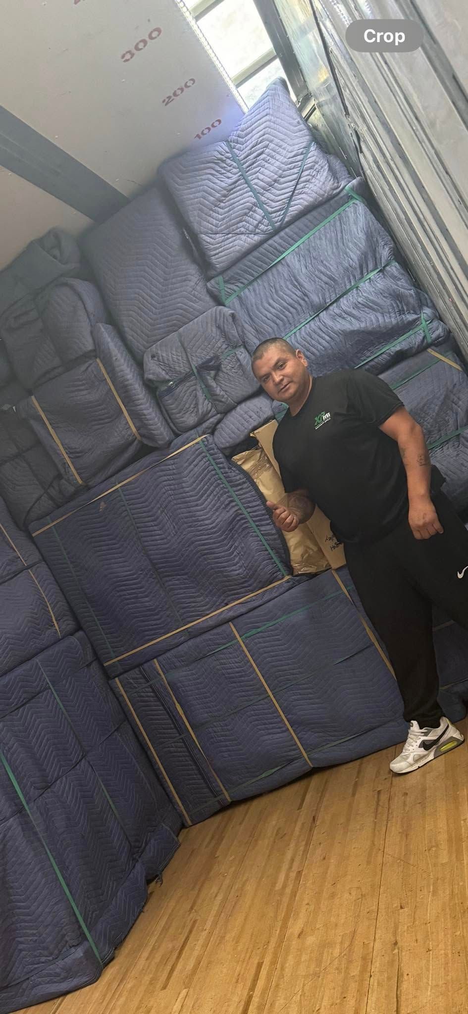 A man is taping a cardboard box with tape.