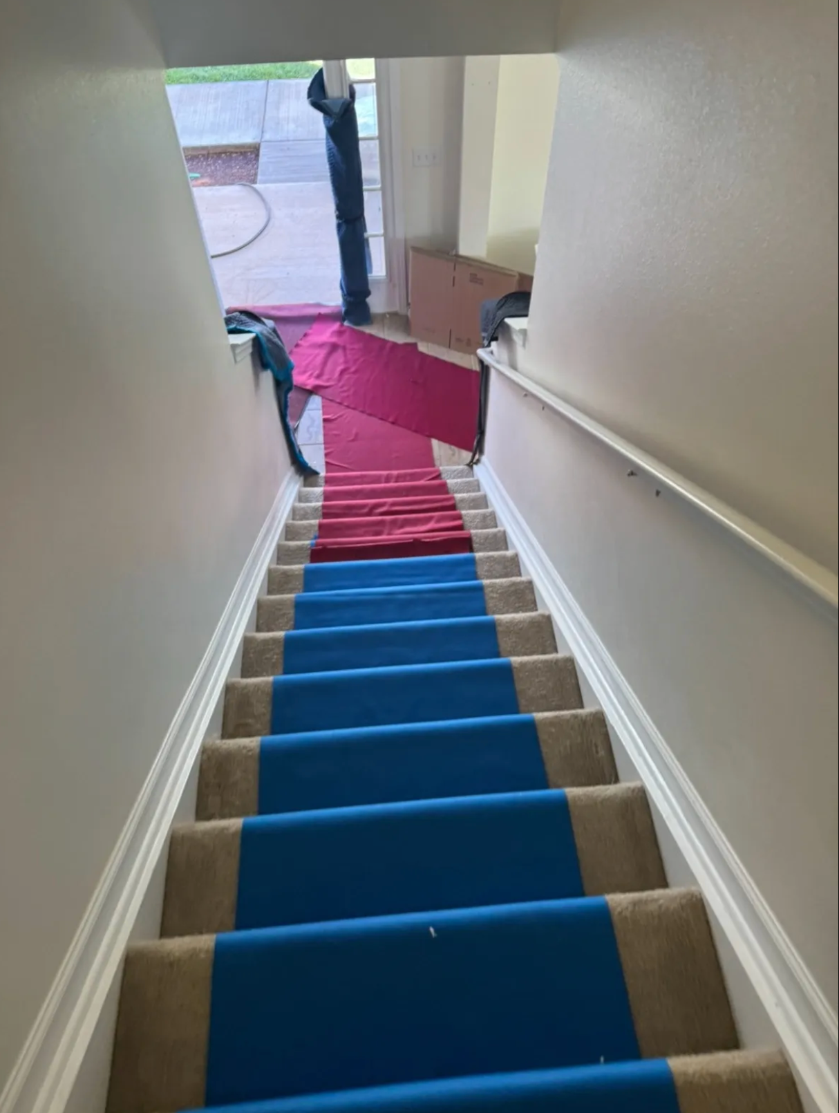 A set of stairs with blue and red carpet on them.