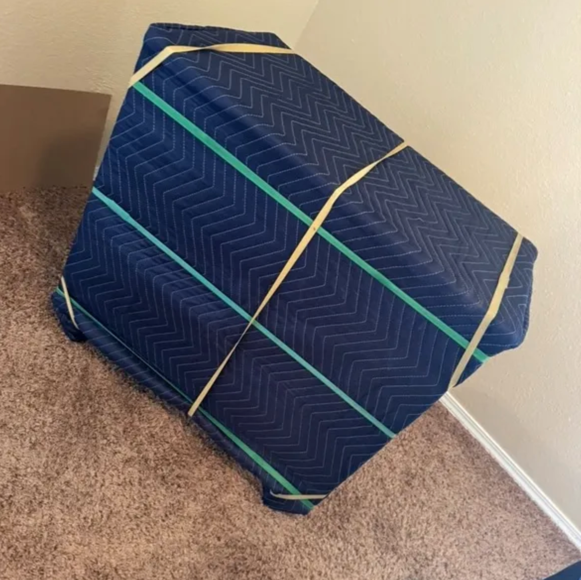 A man is walking up a set of stairs in a hallway.