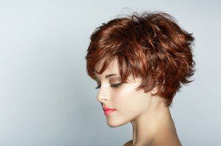 A lady with a short brown pixie cut with red lowlights
