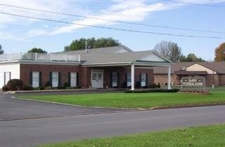 A large brick building with a sign in front of it.