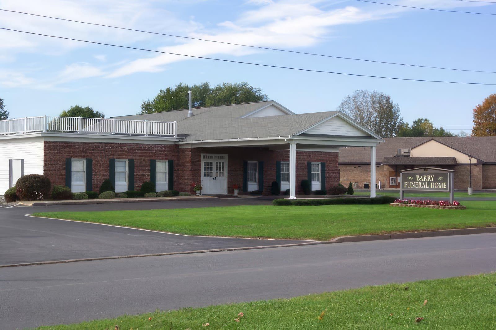 A family is sitting on the grass in a park.