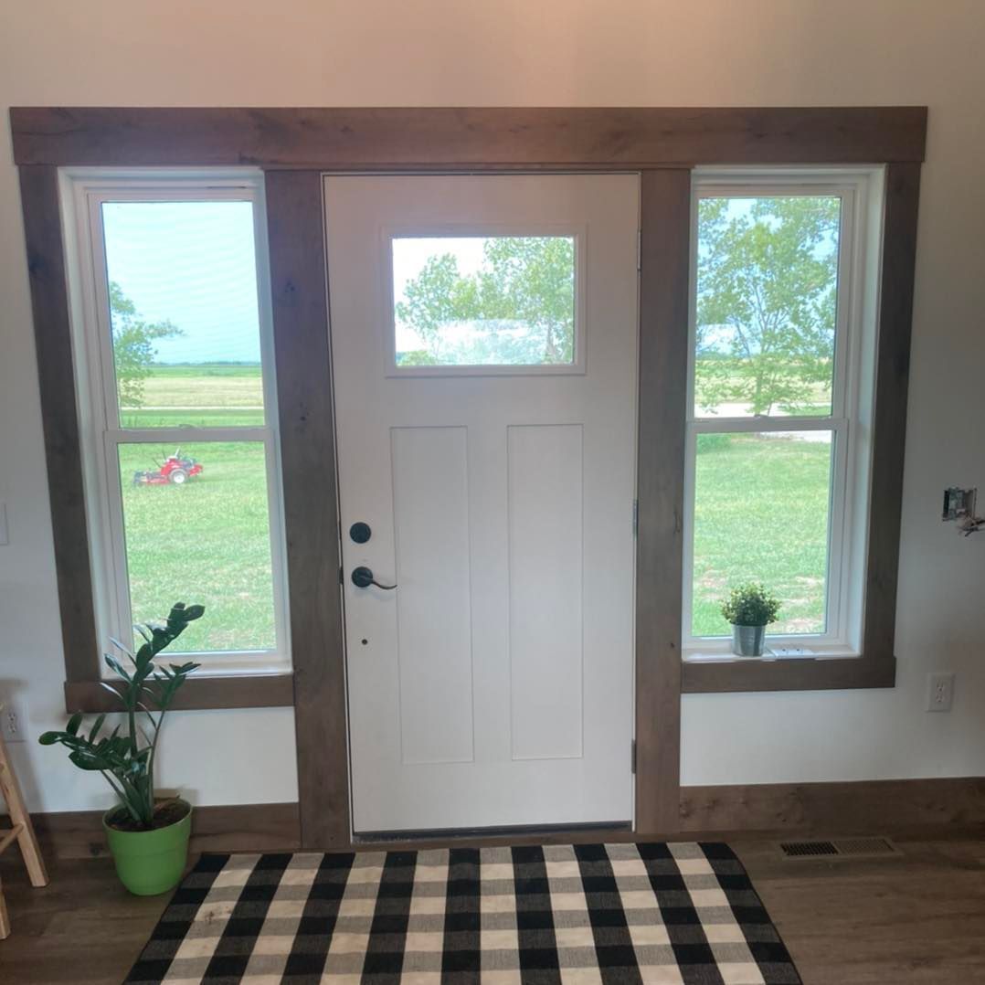A white door with a black and white checkered rug in front of it