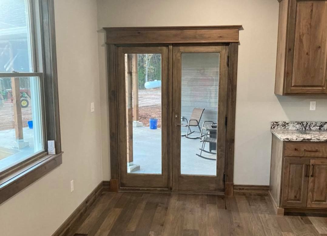A room with sliding glass doors leading to a patio.