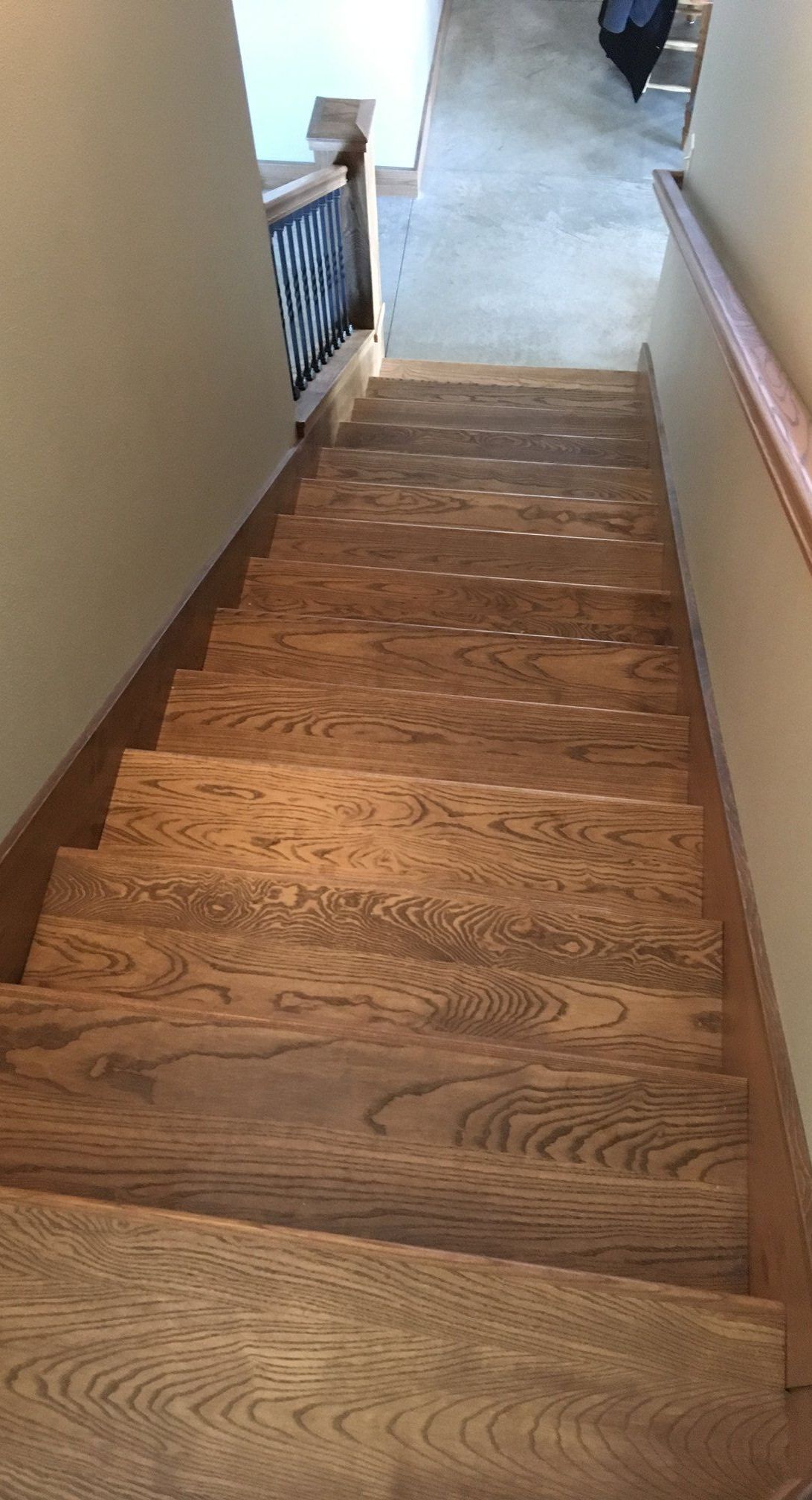A wooden door leading to a bathroom with a sink and mirror.