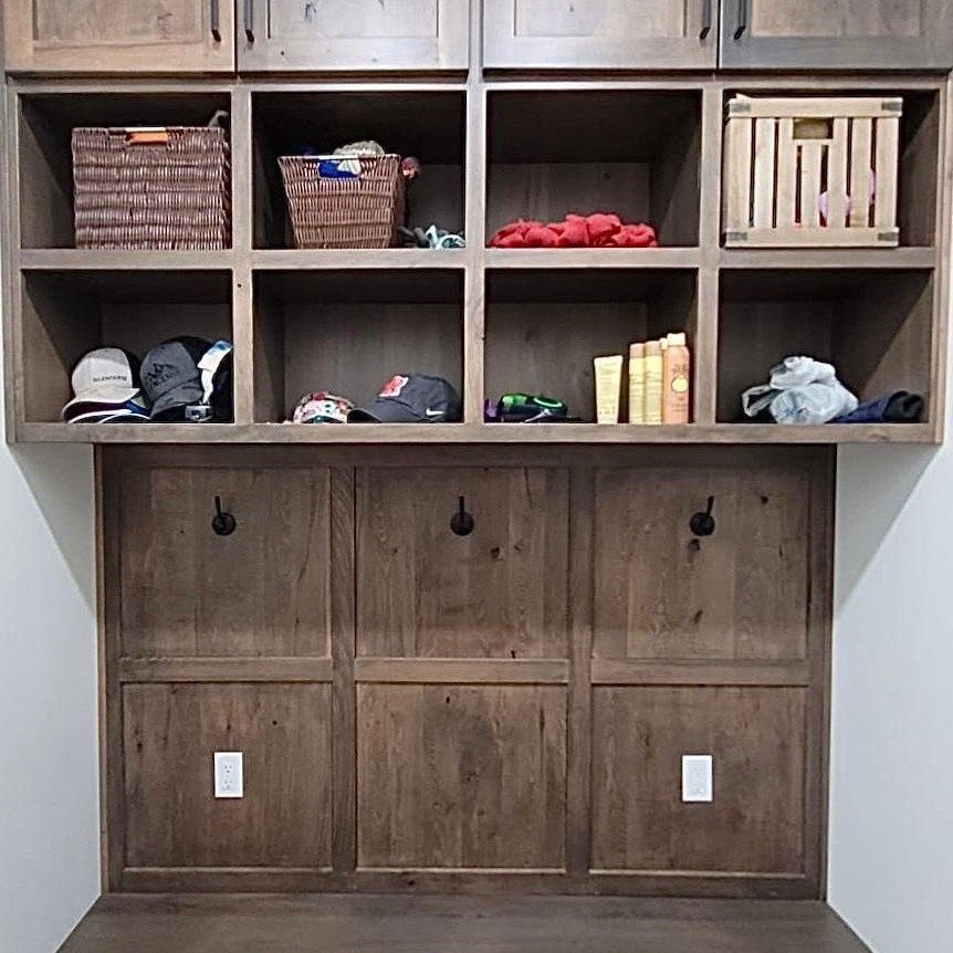 A laundry room with lots of shelves and drawers