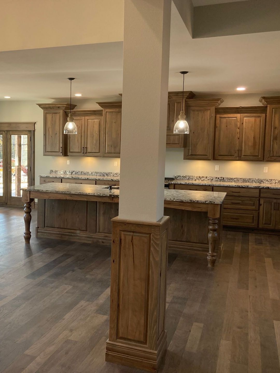 A kitchen with wooden cabinets and a large island.