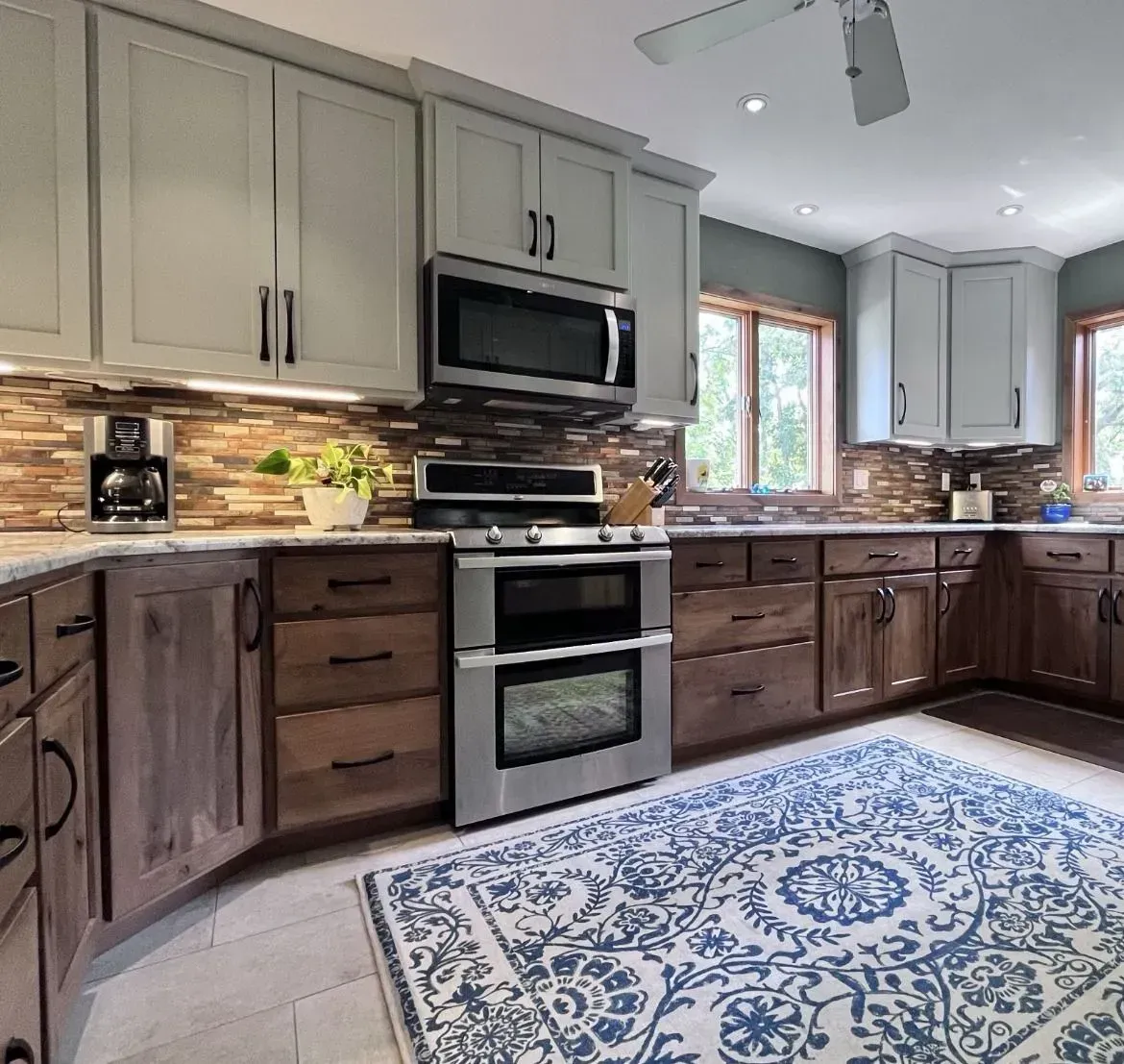 A kitchen with stainless steel appliances and wooden cabinets