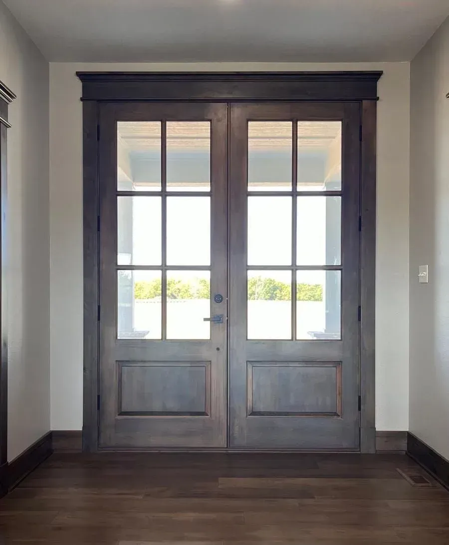 A hallway with a door that has a lot of windows