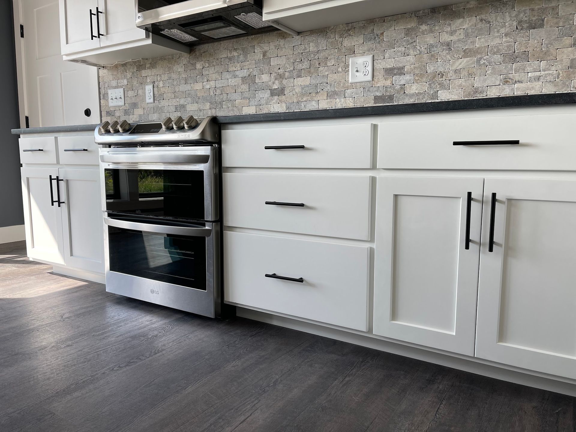 A kitchen with white cabinets and stainless steel appliances.