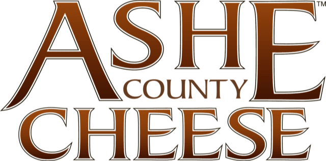 The logo for ash county cheese is brown and white