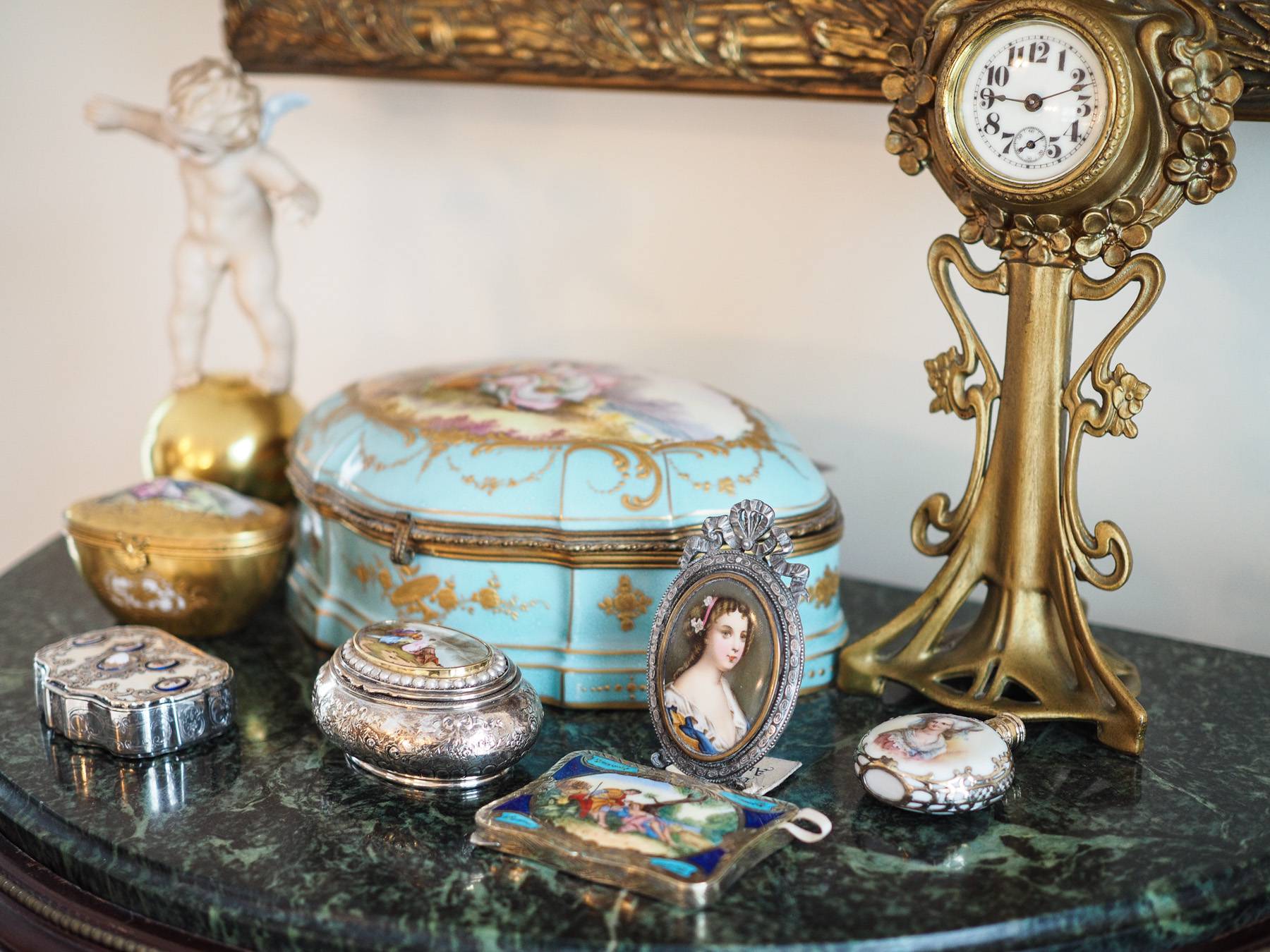 granite table with an old clock, and old pretty trinkets