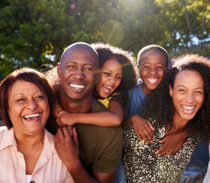 A group of people are posing for a picture together and smiling.