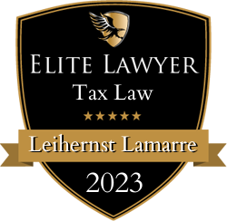 A shield with the words elite lawyer tax law on it