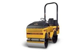 Yellow and black road roller compacting ground on a white background.