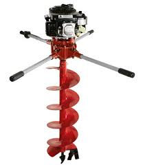 Red and black gas-powered post hole digger, with a long drill bit and handles extending outwards.