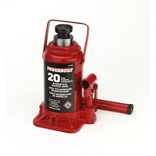 Red Powerbuilt 20-ton hydraulic bottle jack on a white surface.
