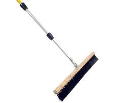 Long-handled push broom with black bristles, a wooden base, and an extendable silver handle.