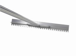Metal serrated edge tool, likely used for leveling or spreading materials.