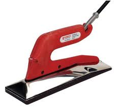 Red and silver seam iron for flooring installation.