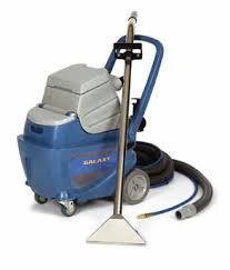 Blue and gray carpet cleaner with a silver wand, on a white background.