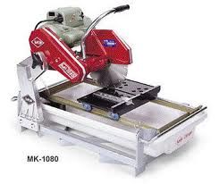 MK-1080 tile saw. Red and silver saw with a diamond blade, water tray, and cutting table.