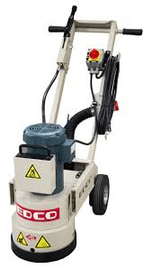 Gray and beige concrete floor grinder with wheels, handles, and power cord.