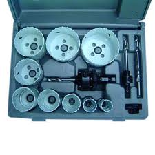 A set of hole saw bits and accessories in a gray plastic case.