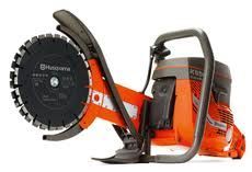 Orange and gray Husqvarna power cutter with black circular saw blade.