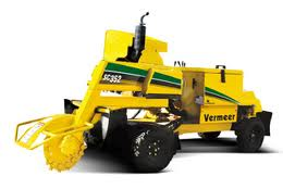 Yellow Vermeer SC352 stump grinder with a grinding wheel ready to remove a tree stump.
