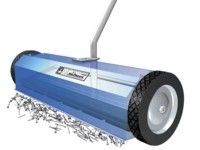 Blue magnetic sweeper rolling on a surface, collecting nails and screws.