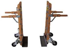Two wooden ladder jacks with adjustable arms, resting on wheels, side view.