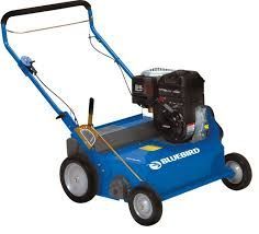 Bluebird lawn dethatcher, blue, with a black engine, in a yard setting.