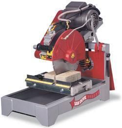Tile saw cutting a block of tile, red and gray with a water reservoir.
