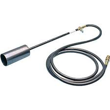 Torch head with a metal cylinder, connected by a hose to a valve and gas fitting.