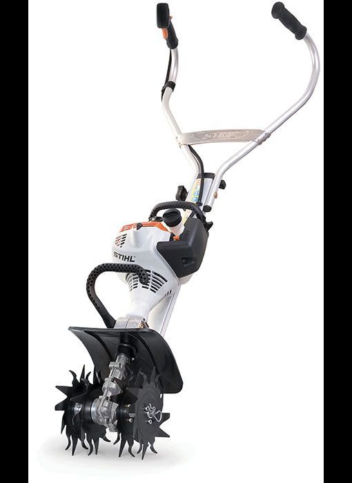 A white and orange STIHL garden tiller with black blades and handlebars, isolated on white.