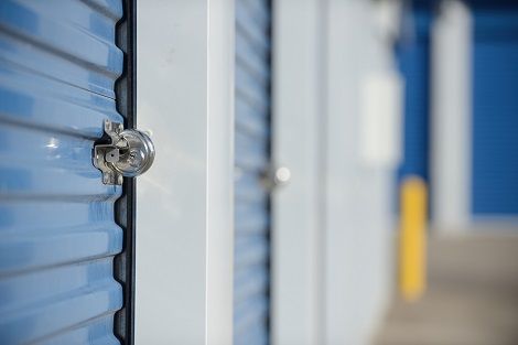 Close-up of a locked blue unit door, at a climate-controlled self-storage facility.